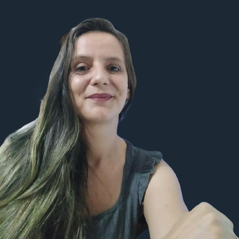 Foto de perfil de uma mulher sorrindo ao lado de um computador 